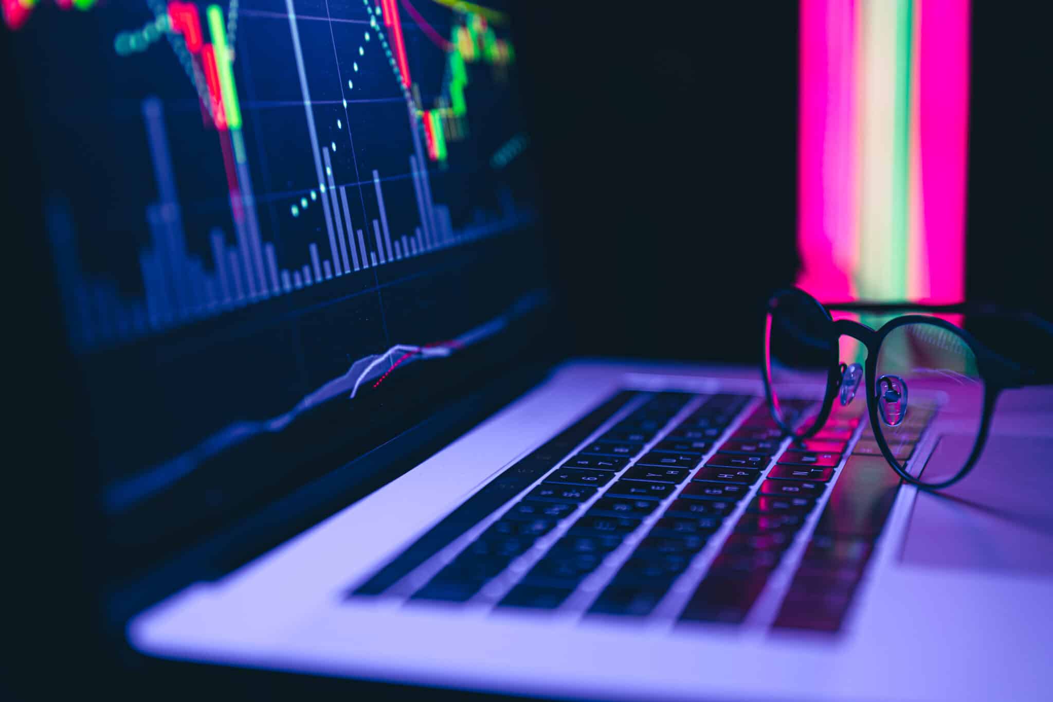 Cryptocurrency graph as Bitcoin graphs on the device as computer laptop, smartphone at home. Young money investing concepts.